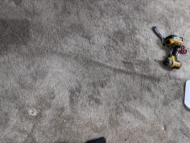 Before repair showing the damaged carpet area